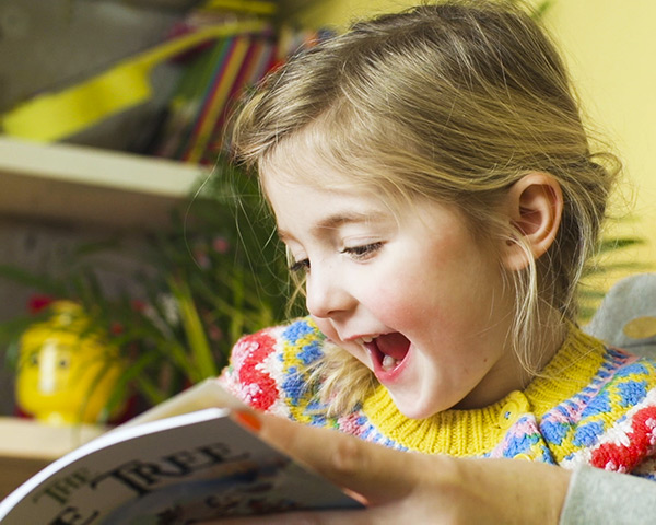 Child having fun with the meet the characters book