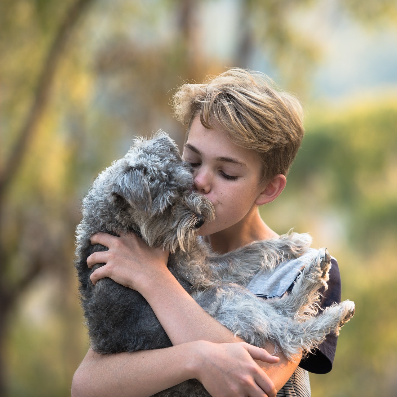 boy hugging dog